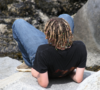 Photo of a boy gazing off into nature